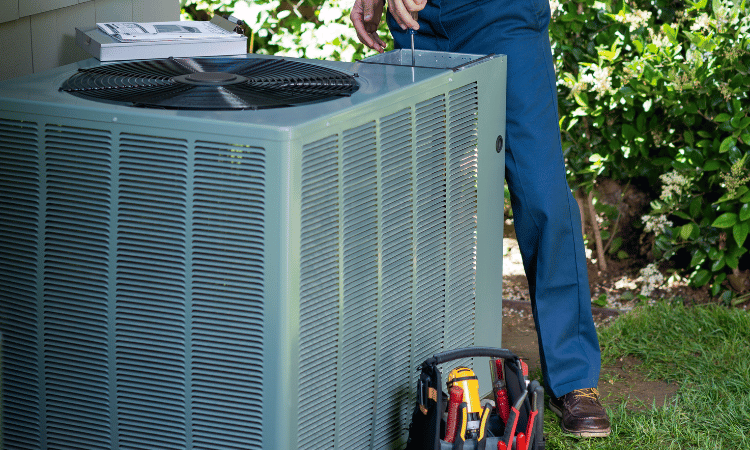 technician doing maintenance on outdoor air conditioning unit