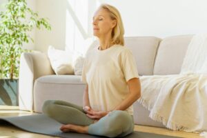 older woman doing yoga and deep breathing