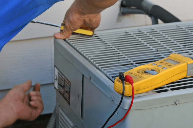 technician testing ac unit for repairs