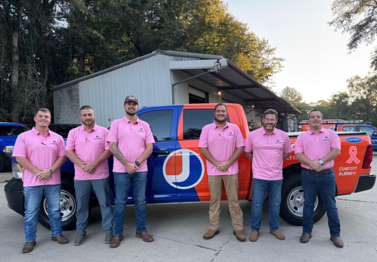 Jackson team members pose in breast cancer awareness apparel.